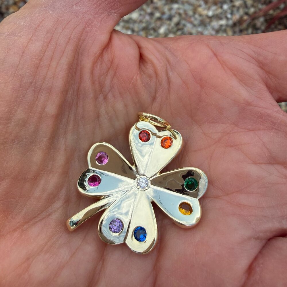 Gold four-leaf clover pendant with rainbow cubic zirconia stones